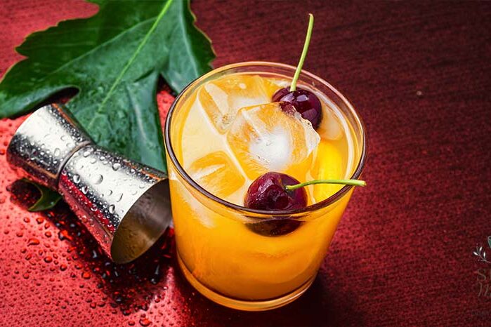 Summertime Orange Drink with Ice and Cherries