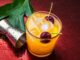 Summertime Orange Drink with Ice and Cherries