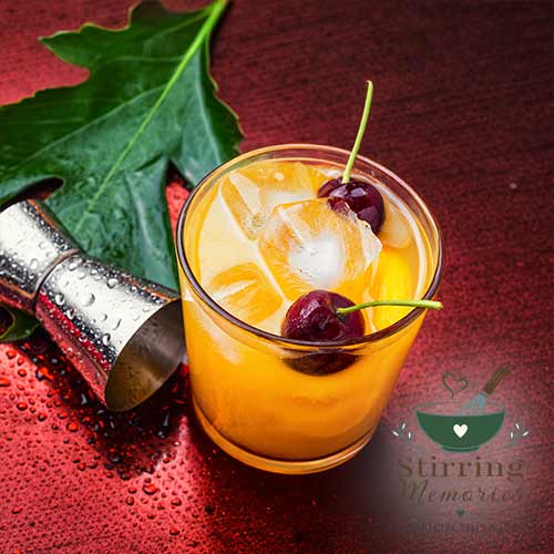 Summertime Orange Drink with Ice and Cherries